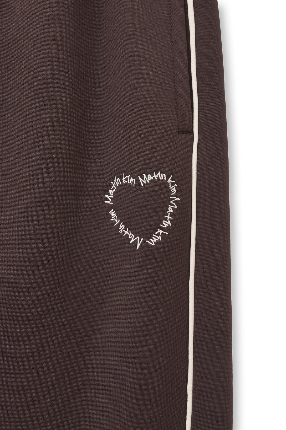 [matinkim] HEART LOGO TRACK PANTS IN BROWN