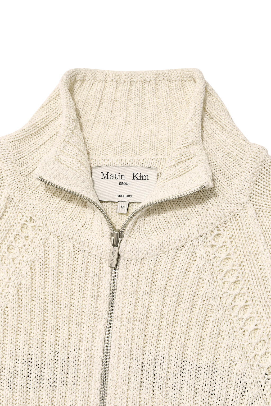 [matinkim] BACK LOGO HIGH NECK KNIT VEST IN LIGHT BEIGE