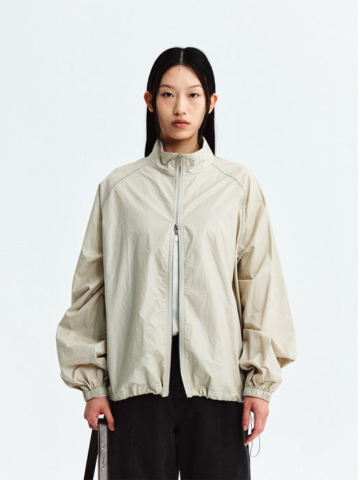 MATIN KIM LOGO COATING JUMPER IN BEIGE