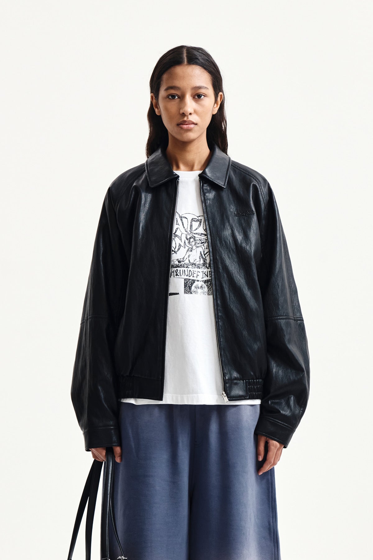 [matinkim] SMALL LOGO QUILTED FAUX LEATHER ZIP UP JUMPER IN BLACK