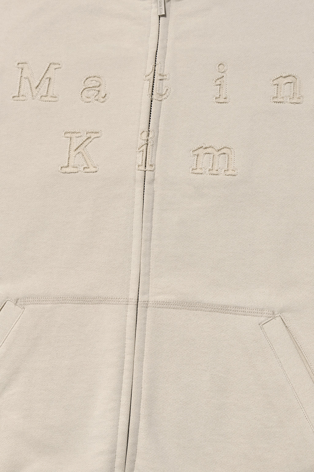[matinkim] APPLIQUE CUTTED LOGO HOODY ZIP UP IN BEIGE