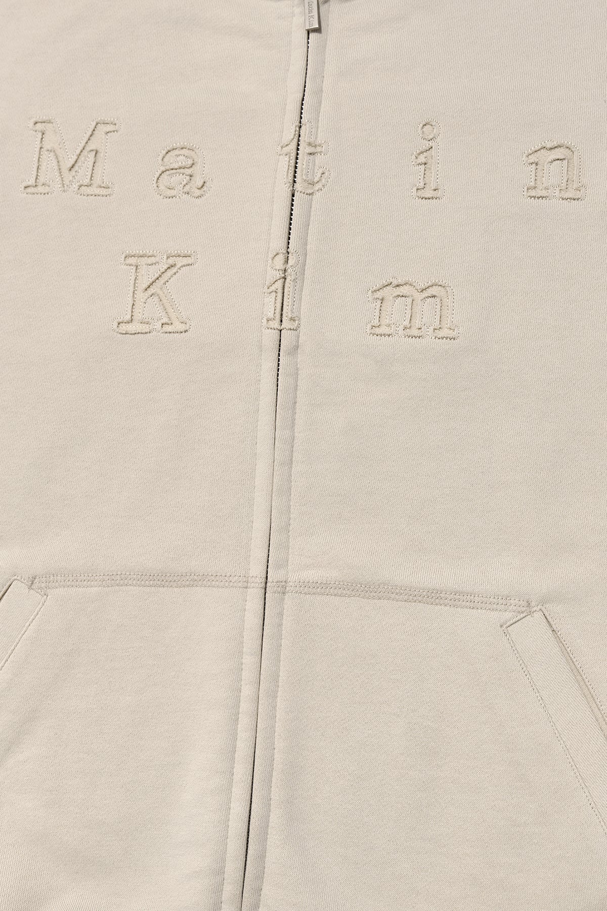 [matinkim] APPLIQUE CUTTED LOGO HOODY ZIP UP IN BEIGE