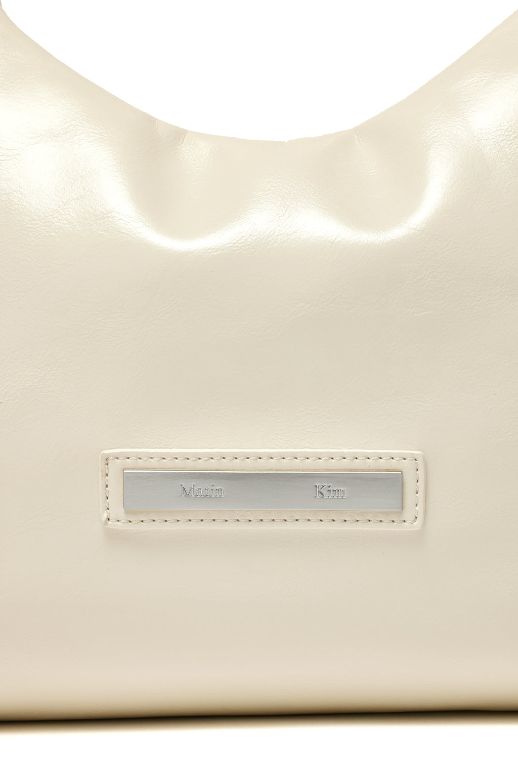 [matinkim] EMBOSSED LOGO LEATHER MINI TOTE BAG IN IVORY