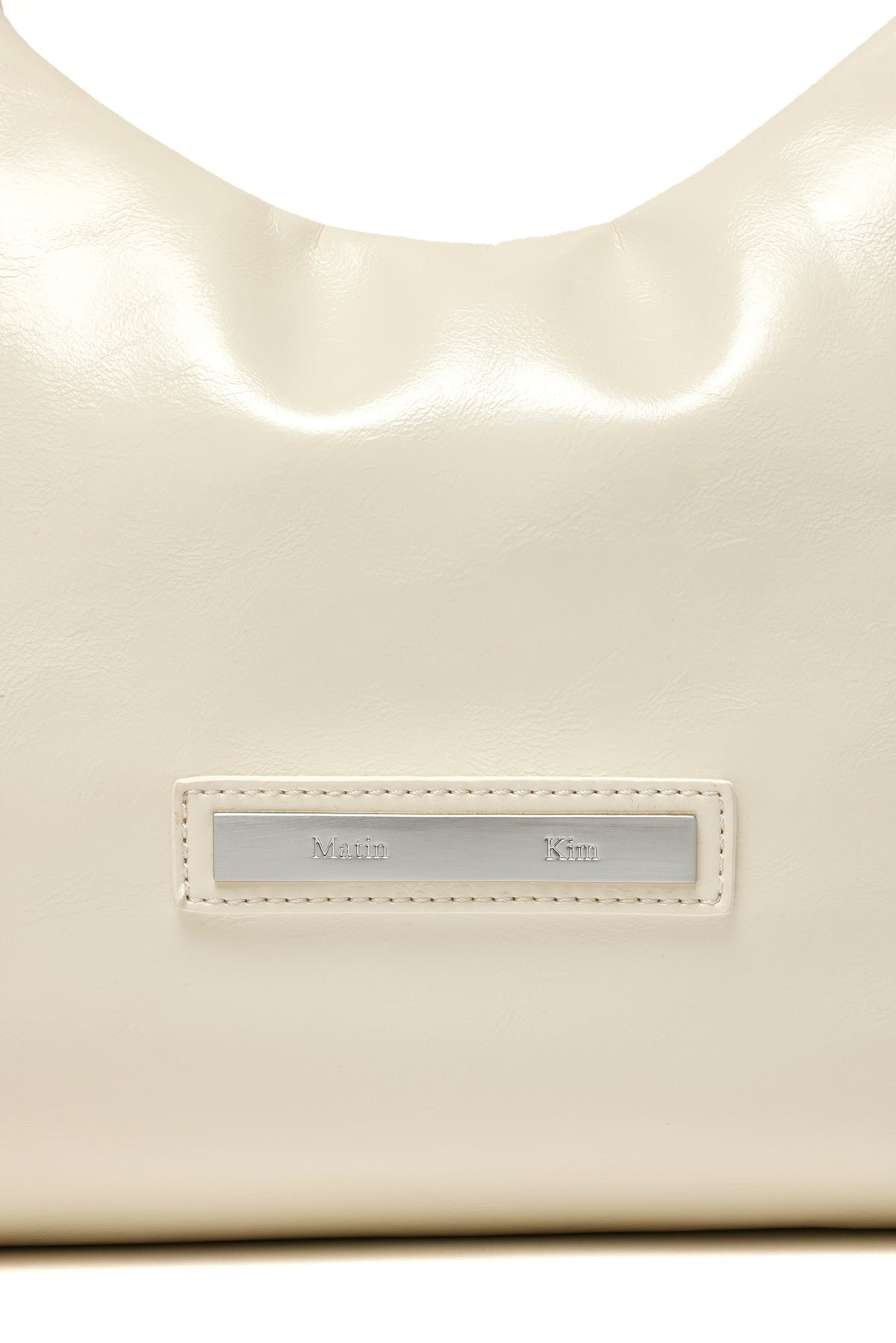 [matinkim] EMBOSSED LOGO LEATHER MINI TOTE BAG IN IVORY