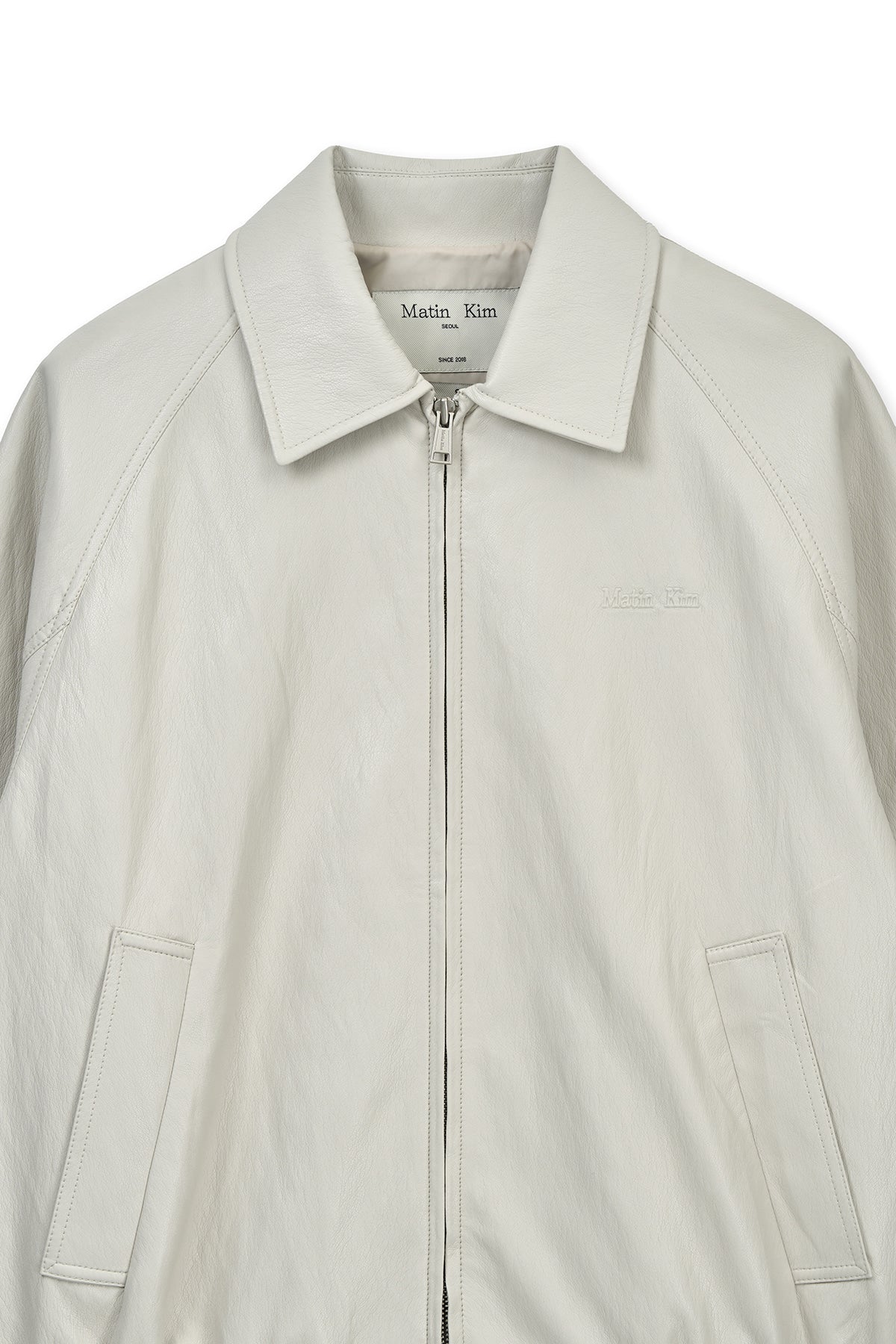 [matinkim] SMALL LOGO FAUX LEATHER ZIP UP JUMPER IN LIGHT GREY