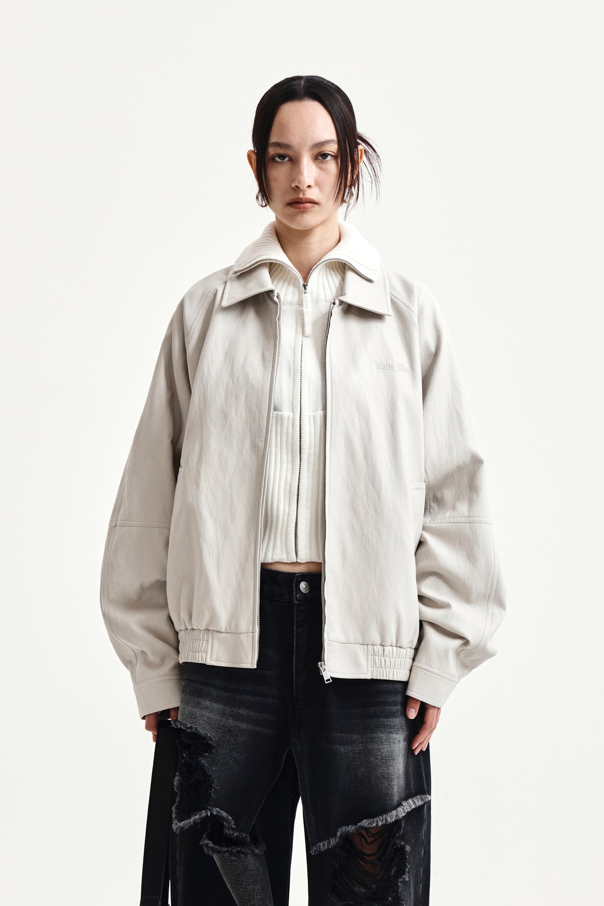 [matinkim] SMALL LOGO FAUX LEATHER ZIP UP JUMPER IN LIGHT GREY