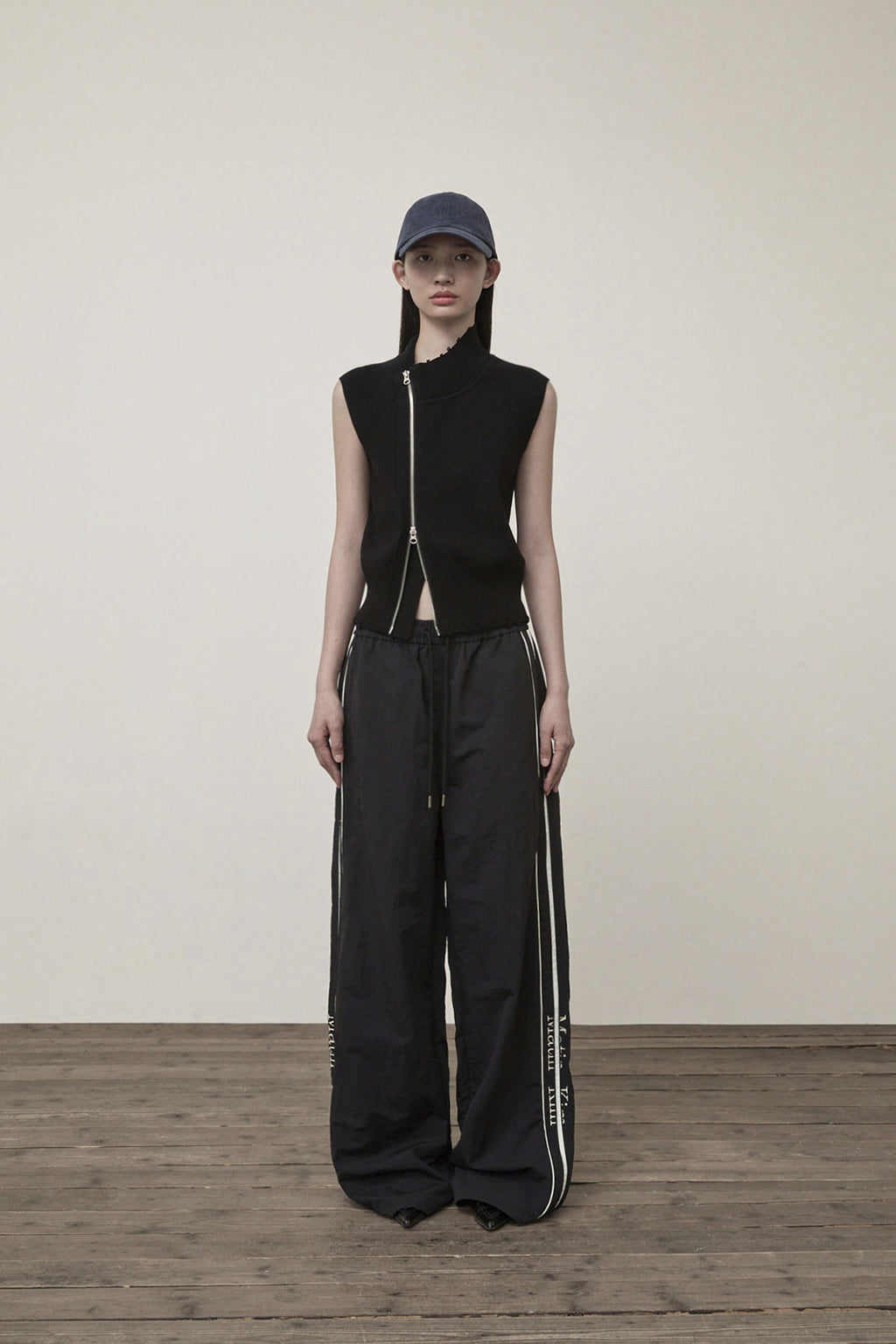 [matinkim] HIGH NECK LOGO KNIT ZIP UP VEST IN BLACK