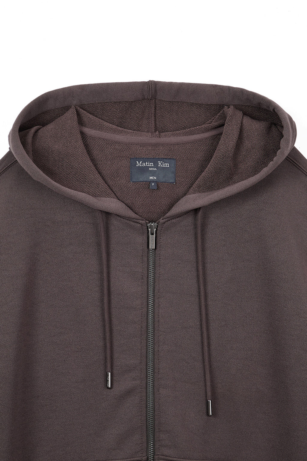 [matinkim] BACK LOGO GLITTER HOODY ZIP UP FOR MEN IN BROWN