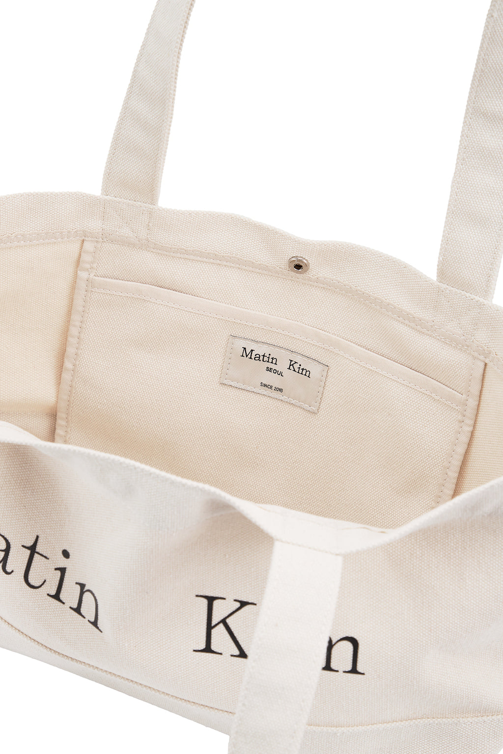 [matinkim] MATIN LOGO CANVAS WIDE SHOULDER BAG IN IVORY