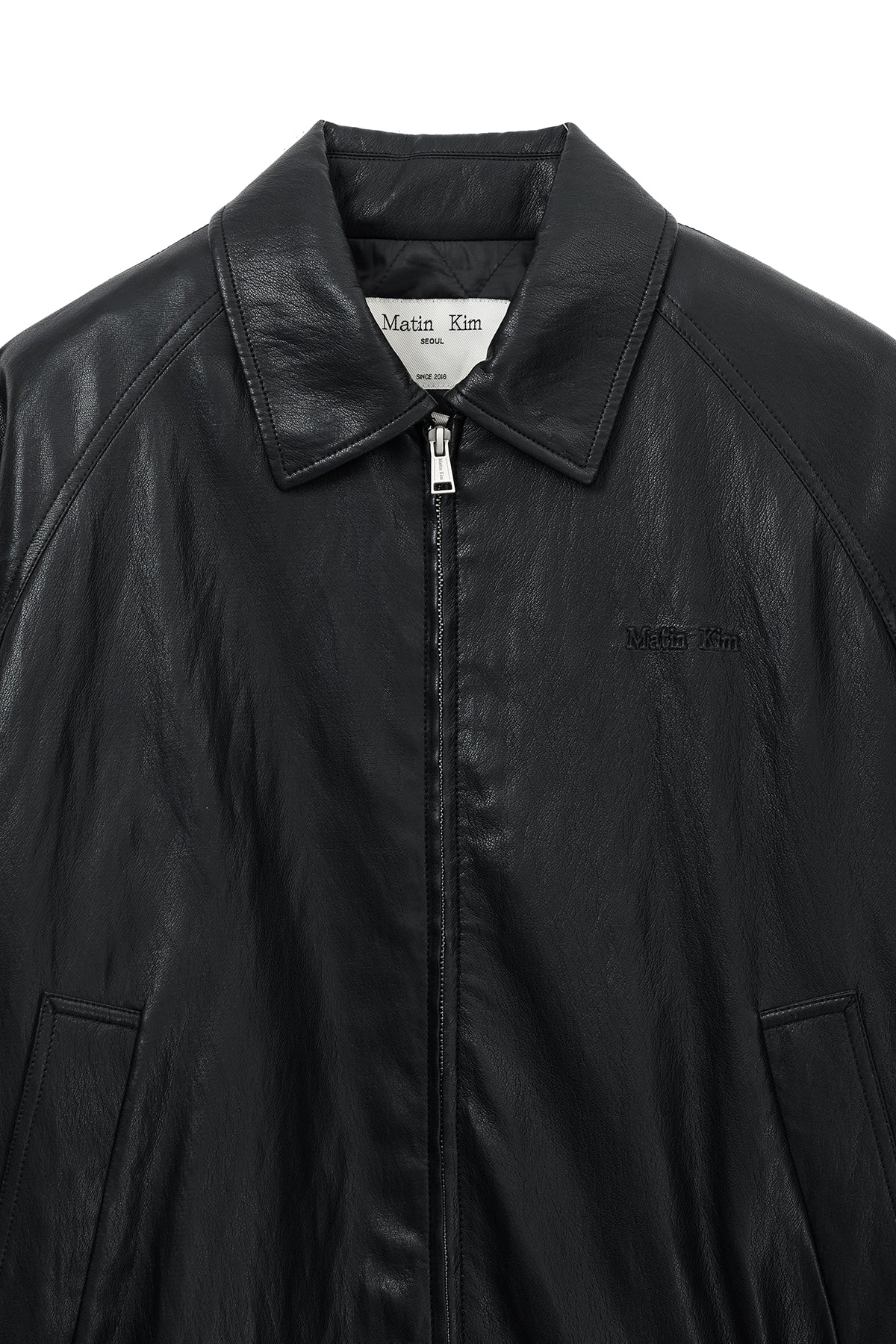 [matinkim] SMALL LOGO QUILTED FAUX LEATHER ZIP UP JUMPER IN BLACK