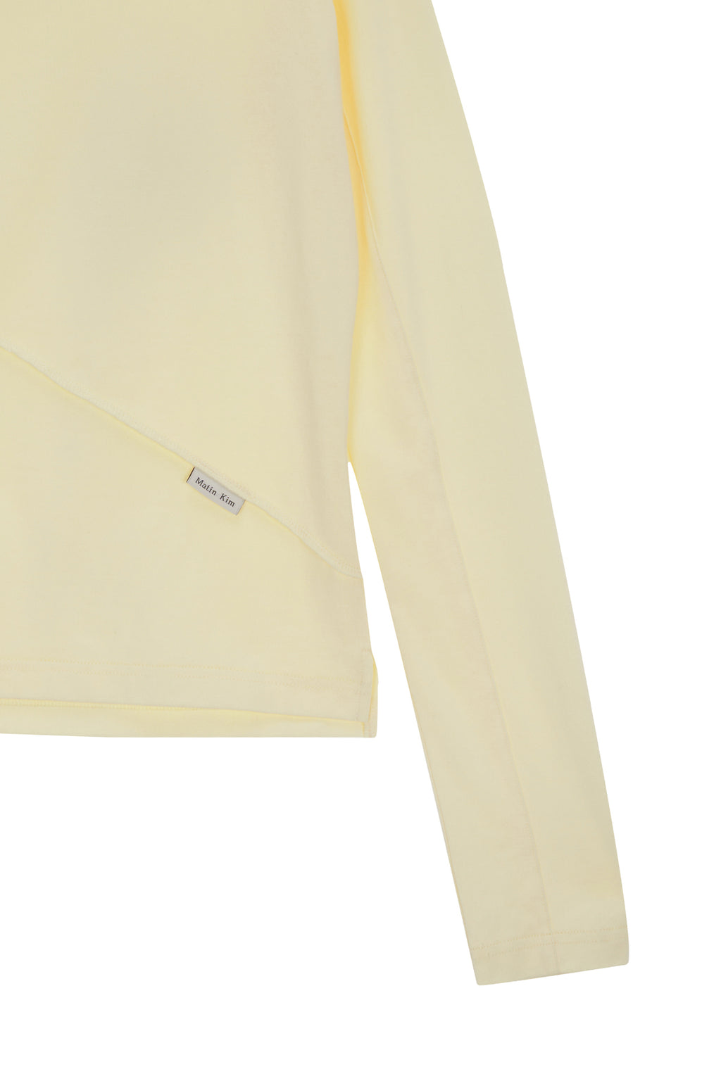 [matinkim] DIAGONAL SLIMFIT LONG SLEEVE TOP IN LIGHT YELLOW