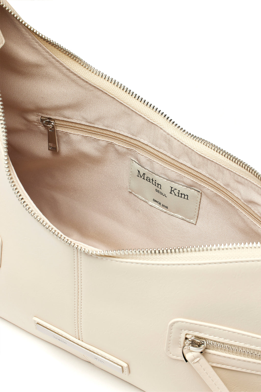 [matinkim] ASYMMETRICAL ZIPPER BAG IN IVORY