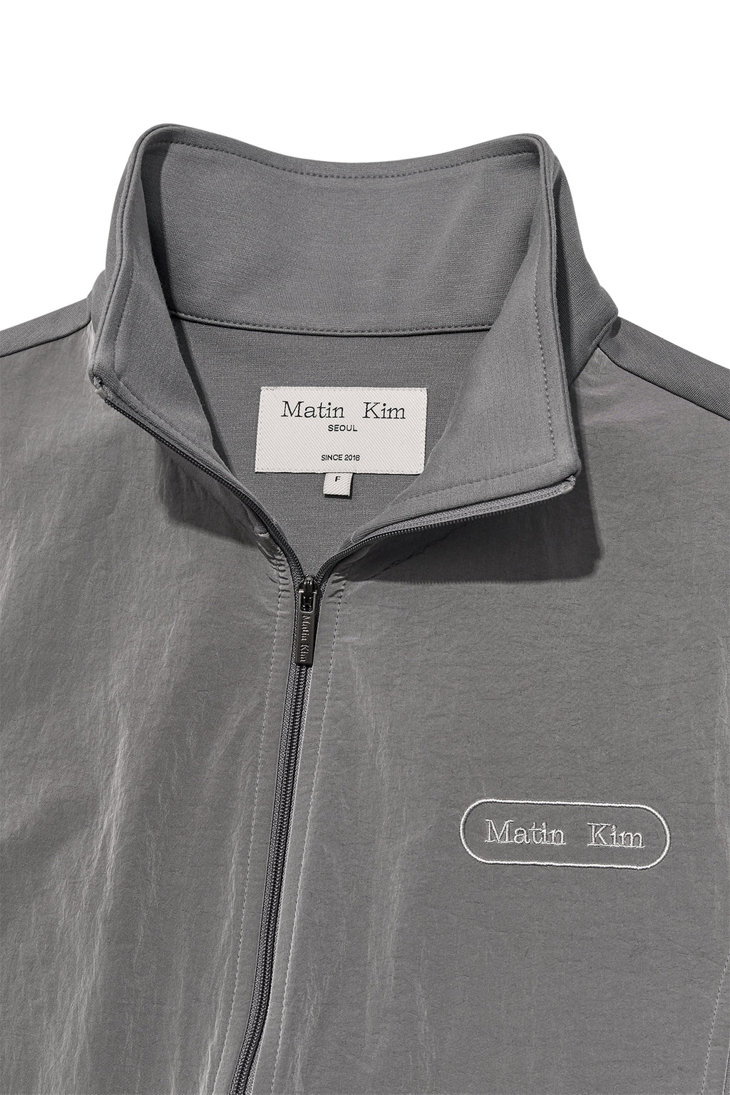 [matinkim] HIGH NECK WINDBREAKER ZIP UP FOR WOMEN IN GREY