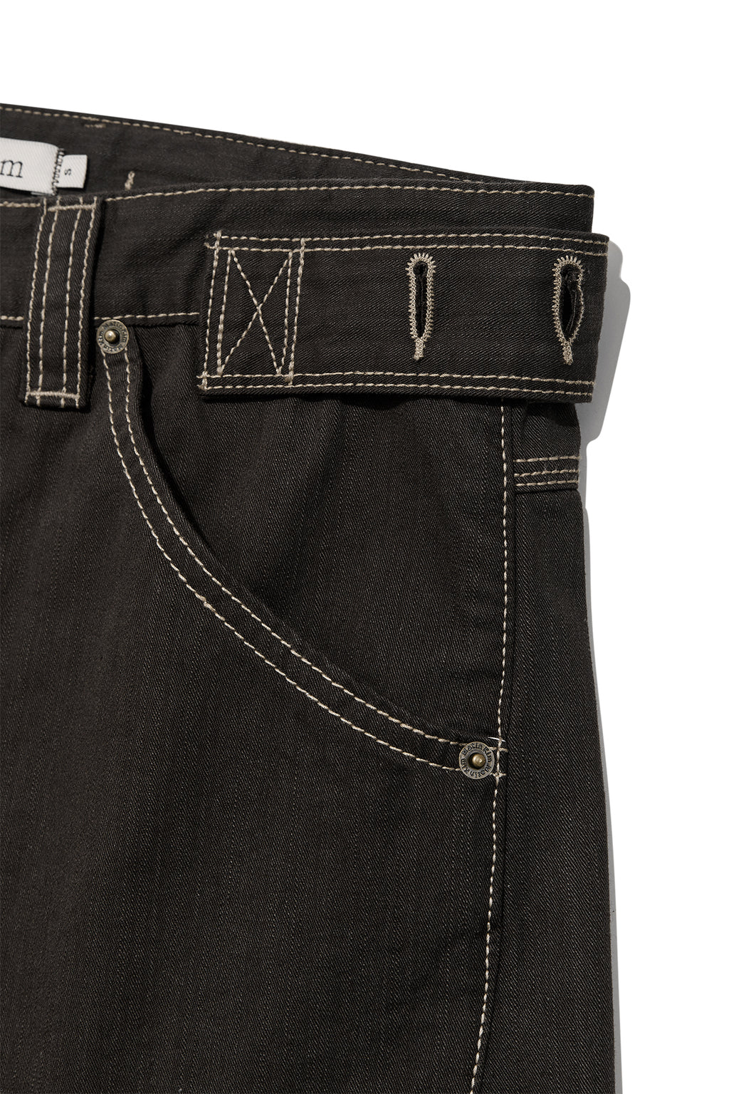 [matinkim] WAIST BUCKLE CURVED TWILL DENIM PANTS IN CHARCOAL