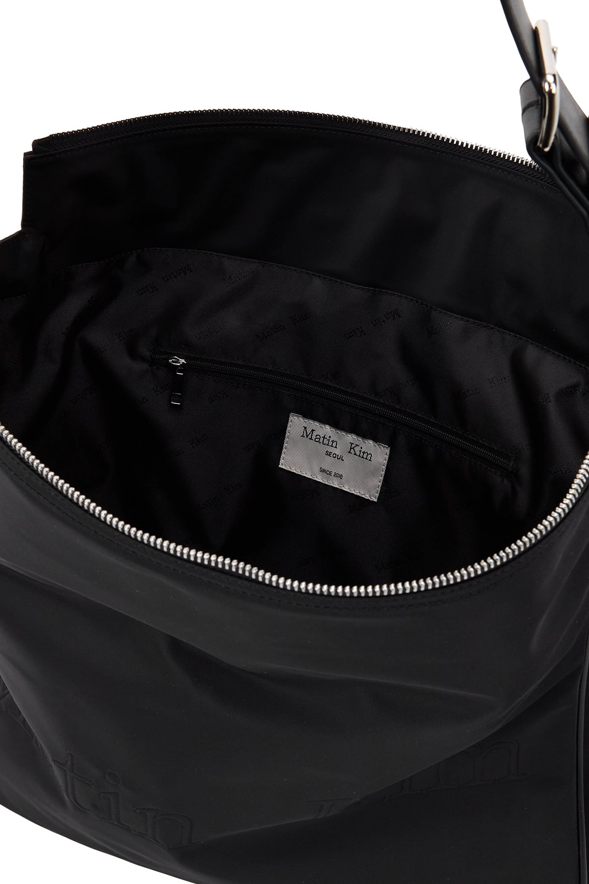 [matinkim] EMBOSSED LOGO FABRIC SHOULDER BAG IN BLACK