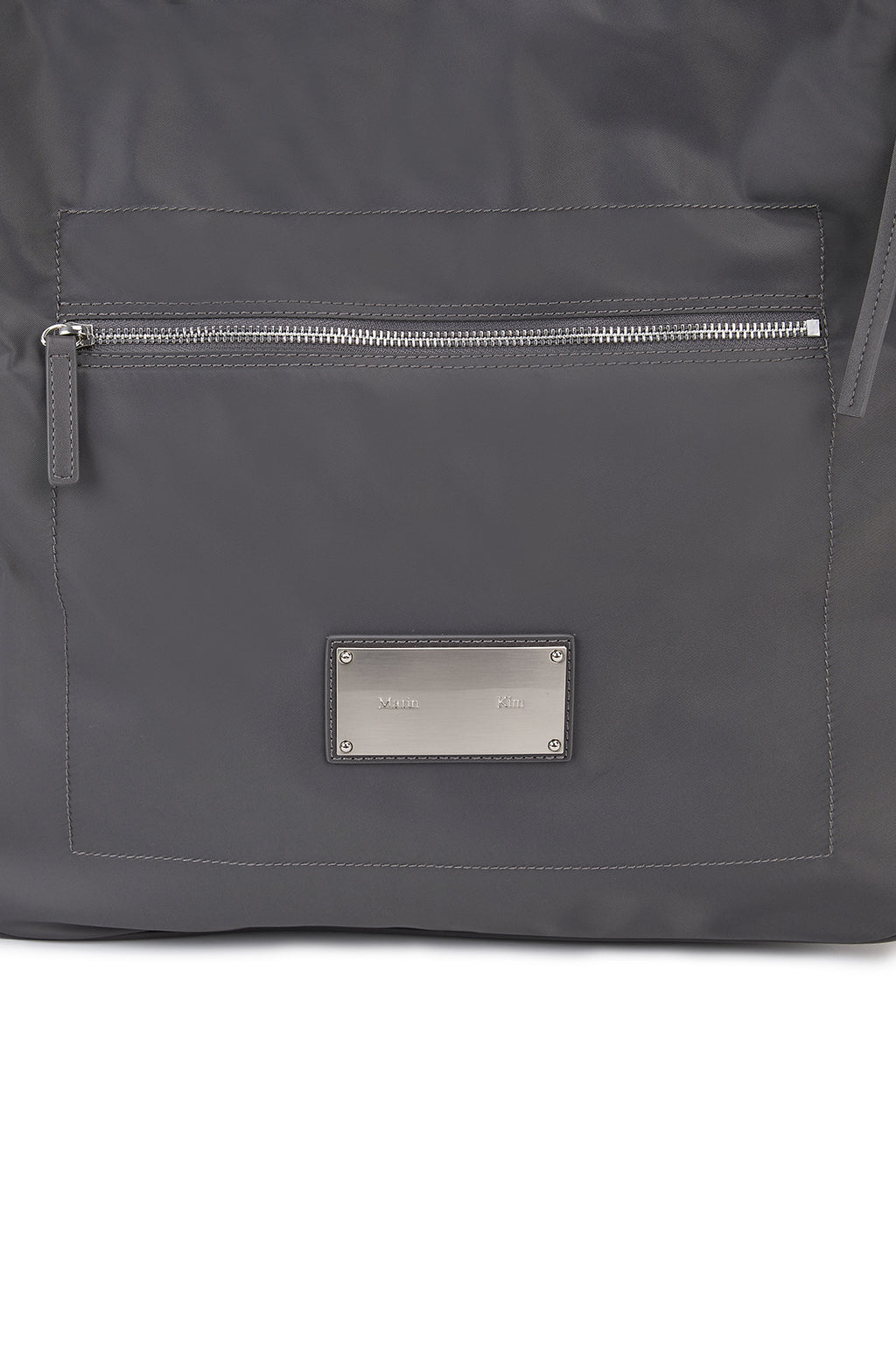 [matinkim] EMBOSSED LOGO FABRIC SHOULDER BAG IN CHARCOAL