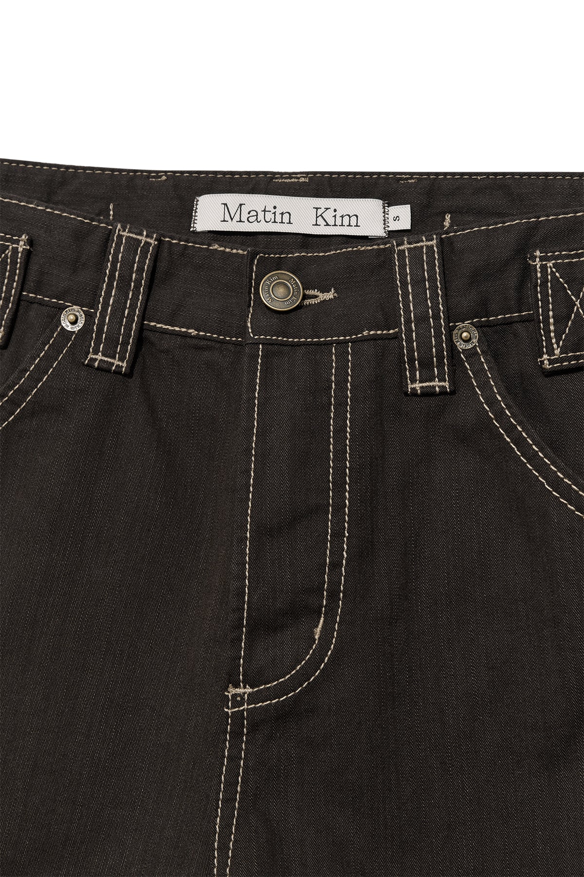 [matinkim] WAIST BUCKLE CURVED TWILL DENIM PANTS IN CHARCOAL
