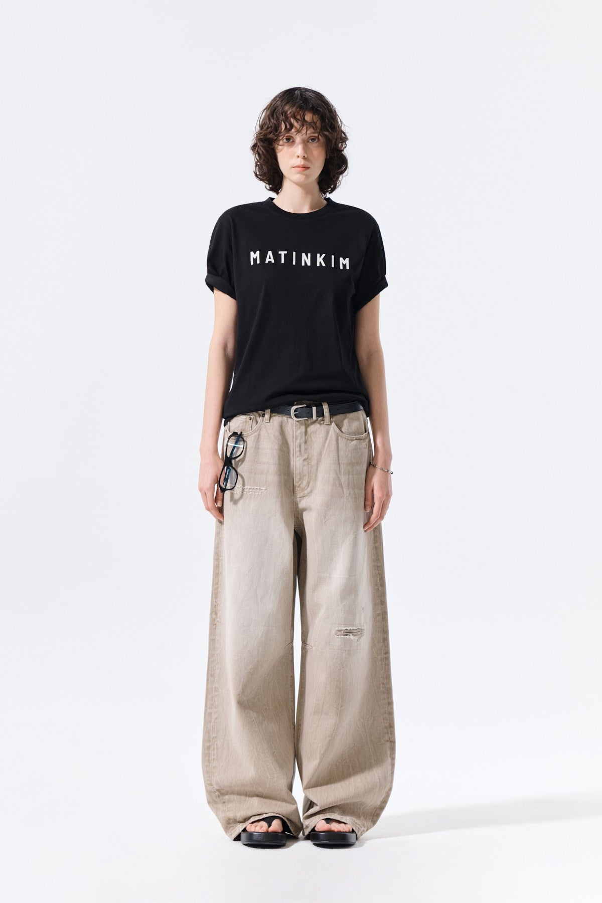 Matinkim Back Logo Washed Denim Pants IN Beige
