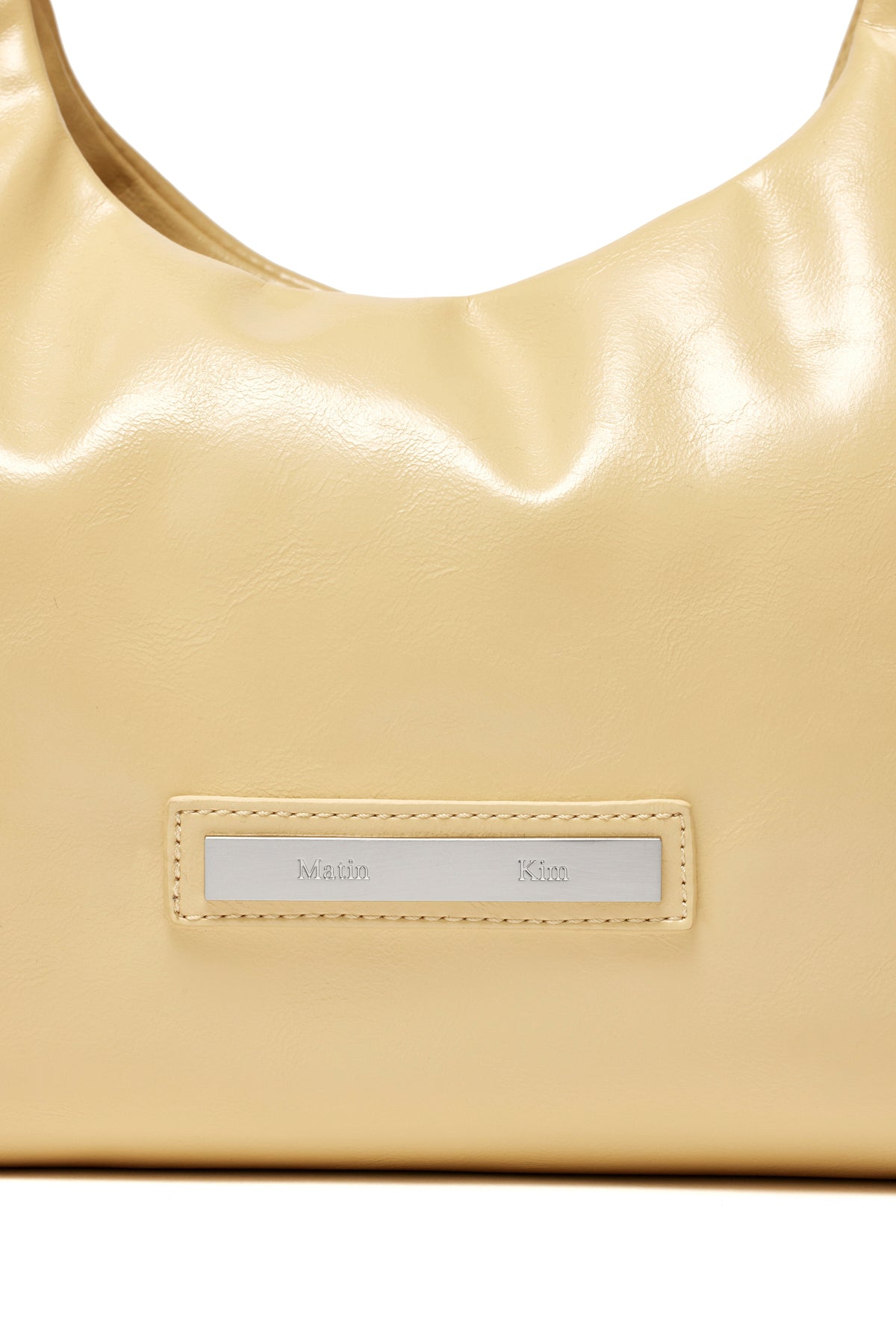 [matinkim] EMBOSSED LOGO LEATHER MINI TOTE BAG IN LIGHT YELLOW