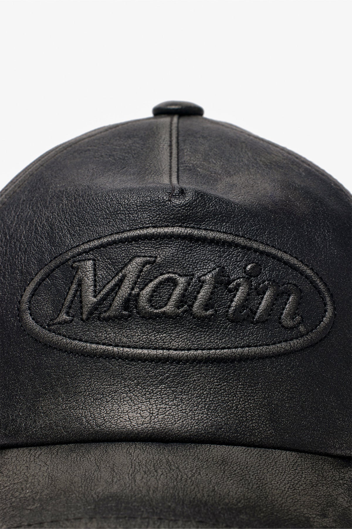 [matinkim] EMBOSSED LOGO LEATHER BALL CAP IN BLACK